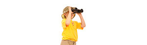 Explorer, curious young boy looking up through binoculars